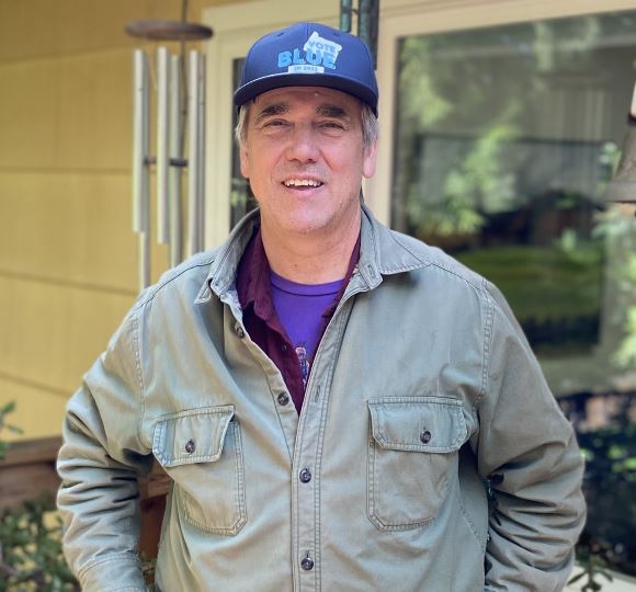 Senator Merkley wearing a Vote Blue hat